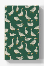 Load image into Gallery viewer, A hardcover notebook with a dark green cover featuring a repeating pattern of white ducks with yellow beaks and feet, shown on a light gray background with a soft drop shadow.