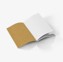 Load image into Gallery viewer, An open notebook with lined white pages on one side and a textured gold cover with a subtle rose pattern on the other, shown on a clean white background.