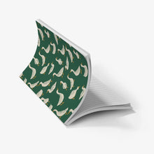 Load image into Gallery viewer, An open notebook with a dark green cover patterned with cream ducks, showing lined white pages underneath, set against a plain white background.
