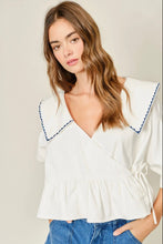 Load image into Gallery viewer, Woman wearing a white blouse with blue trim against a plain background