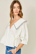 Load image into Gallery viewer, Woman wearing a white blouse with blue trim on a plain background