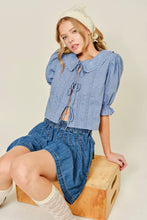 Load image into Gallery viewer, Woman wearing a blue denim outfit sitting on a wooden block against a plain background