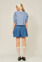 Load image into Gallery viewer, Person wearing a blue checkered shirt and denim shorts on a plain background