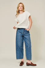 Load image into Gallery viewer, Woman wearing a white top and blue jeans against a plain background