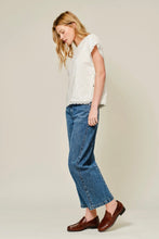 Load image into Gallery viewer, Woman wearing a white top and blue jeans on a plain background