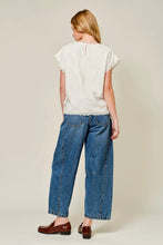 Load image into Gallery viewer, Woman wearing a white top and blue jeans on a plain background