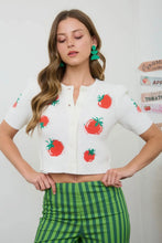 Load image into Gallery viewer, Woman wearing a white blouse with red tomato patterns and green checkered pants against a light background.