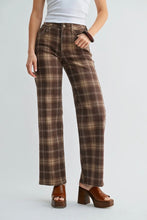 Load image into Gallery viewer, A model wearing brown and beige plaid wide-leg pants, styled with a white tank top and brown platform sandals against a light gray studio background.