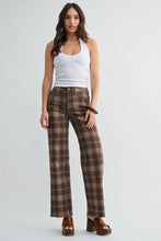 Load image into Gallery viewer, A woman modeling a pair of brown and beige plaid wide-leg pants with a white ribbed tank top and brown platform sandals, standing against a light gray studio background.