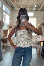 Load image into Gallery viewer, Person taking a mirror selfie wearing a patterned top and jeans in a store.