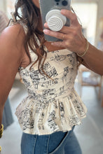Load image into Gallery viewer, Person wearing a patterned top and jeans, taking a mirror selfie.