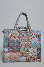 Load image into Gallery viewer, A patchwork quilted tote bag with floral and striped fabric panels, featuring two top handles, shown against a plain light gray background.