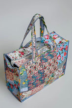 Load image into Gallery viewer, A patchwork quilted tote bag with floral and striped fabric panels, featuring two shoulder straps, shown on a neutral light gray background.