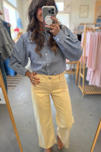 Load image into Gallery viewer, Person taking a mirror selfie wearing a checkered shirt and yellow pants in a clothing store.