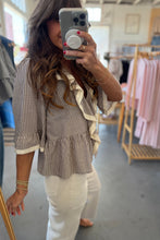 Load image into Gallery viewer, Woman taking a mirror selfie wearing a striped blouse and white pants in a clothing store.