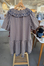 Load image into Gallery viewer, Checkered dress on a hanger in a store setting