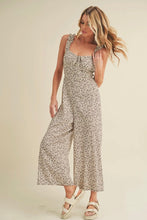 Load image into Gallery viewer, Woman wearing a floral jumpsuit on a plain background