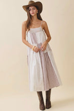 Load image into Gallery viewer, Woman wearing a white dress with brown stripes, brown hat, and brown boots on a beige background