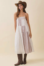 Load image into Gallery viewer, Woman wearing a white dress with striped layers, brown cowboy hat, and boots on a beige background