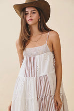 Load image into Gallery viewer, Woman wearing a white and brown striped dress with a wide-brimmed hat on a beige background
