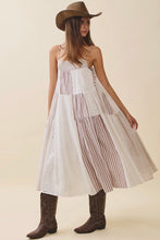 Load image into Gallery viewer, Woman wearing a white dress with brown stripes, brown cowboy hat, and brown boots on a beige background
