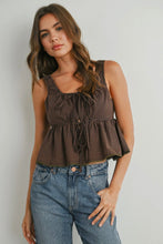 Load image into Gallery viewer, Woman wearing a checkered sleeveless top and blue jeans against a plain background