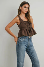 Load image into Gallery viewer, Woman wearing a brown checkered top and blue jeans against a plain background