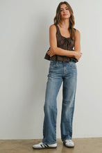 Load image into Gallery viewer, Woman wearing a sleeveless top and jeans standing against a plain background