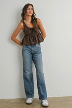 Load image into Gallery viewer, Woman wearing a brown top and blue jeans against a plain background