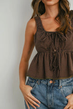 Load image into Gallery viewer, Woman wearing a brown checkered top and blue jeans against a plain background