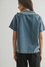 Load image into Gallery viewer, Woman wearing a denim shirt with lace trim on a plain background