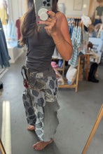 Load image into Gallery viewer, A person taking a mirror selfie in a clothing boutique, wearing a dark gray ribbed tank top and a layered patchwork skirt with gray, black, and white patterns.