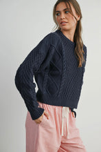Load image into Gallery viewer, Woman wearing a dark blue knitted sweater with a white background
