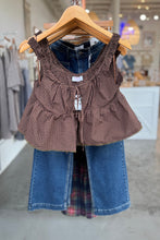 Load image into Gallery viewer, Brown checkered top and blue jeans on a hanger in a store setting