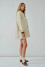 Load image into Gallery viewer, Woman wearing a beige trench coat on a white background