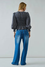 Load image into Gallery viewer, Person wearing a checkered blouse and blue jeans on a plain background