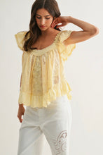 Load image into Gallery viewer, Woman wearing a yellow lace top and white pants against a plain background