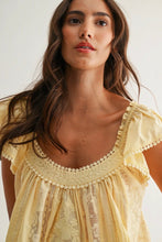 Load image into Gallery viewer, Woman wearing a yellow lace dress against a plain background