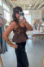 Load image into Gallery viewer, Woman taking a mirror selfie wearing a brown top and black pants in a store.