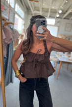 Load image into Gallery viewer, Person wearing a brown top and black pants in a store setting