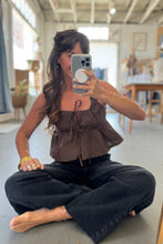 Load image into Gallery viewer, Woman taking a mirror selfie in a casual setting with a blurred background