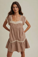 Load image into Gallery viewer, Woman wearing a brown striped dress with lace details on a beige background