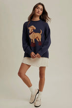 Load image into Gallery viewer, Woman wearing a navy sweater with a dog design on a plain background