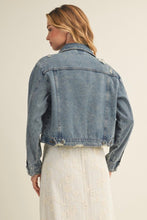 Load image into Gallery viewer, Woman wearing a blue denim jacket on a beige background
