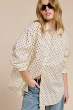 Load image into Gallery viewer, Woman wearing a polka dot blouse and sunglasses against a beige background