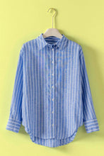 Load image into Gallery viewer, Blue striped shirt on a hanger against a yellow background