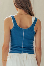 Load image into Gallery viewer, Woman wearing a blue tank top with white trim against a neutral background