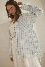 Load image into Gallery viewer, Woman wearing a light blue and white checkered shirt with a plain background