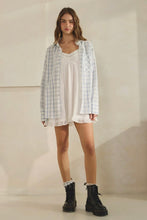 Load image into Gallery viewer, Woman wearing a plaid shirt over a white dress with black boots on a plain background