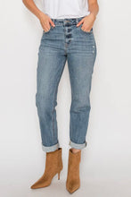 Load image into Gallery viewer, Person wearing light blue jeans and brown ankle boots on a white background